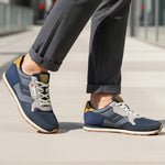 Lifestyle shot of bugatti Sacramento comfort sneakers in navy and gray with a tan accent.