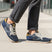 Lifestyle shot of bugatti Sacramento comfort sneakers in navy and gray with a tan accent.