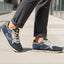Lifestyle shot of bugatti Sacramento comfort sneakers in navy and gray with a tan accent.