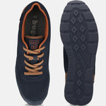 Bugatti Sacramento comfort sneakers in dark blue, shown with brown laces and trim, and patterned soles.
