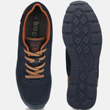 Bugatti Sacramento comfort sneakers in dark blue, shown with brown laces and trim, and patterned soles.
