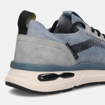 Cropped back view of a bugatti Sandar blue athleisure sneaker, with black pull tab, grey suede accents, and a thick cream and black sole.