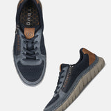 bugatti Compton comfort sneakers in dark blue, featuring laces, a side zipper, and a brown heel accent.
