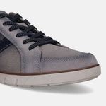 Grey low top sneaker by bugatti with textured sole and dark blue shoelaces, shown in a cropped view.