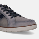 Grey low top sneaker by bugatti with textured sole and dark blue shoelaces, shown in a cropped view.
