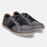 Grey low top sneakers by bugatti featuring dark laces and brown leather heel patch.
