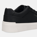 Cropped side view of a black bugatti sneaker with a solid white sole.
