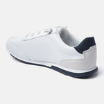 White comfort sneaker by Bugatti featuring a sporty design, textured upper, and dark blue accents.