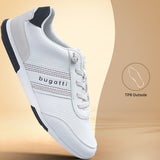 Side view of a white bugatti sneaker with a textured upper, striped accent, and dark navy heel detail.
