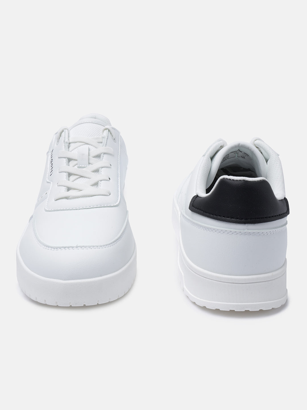 White comfort sneakers by bugatti, featuring a black heel counter and flat white laces.
