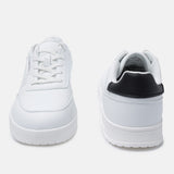 White comfort sneakers by bugatti, featuring a black heel counter and flat white laces.