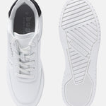 White comfort sneakers by bugatti with laces, padded black collar and patterned rubber sole.