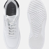 White comfort sneakers by bugatti with laces, padded black collar and patterned rubber sole.