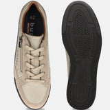 Beige bugatti Trevor comfort sneakers with laces and zipper, shown next to the shoe sole.