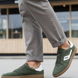 Lifestyle shot of bugatti Carmelo dark green Comfort Sneakers with a white stripe and brown sole.
