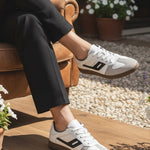 Lifestyle shot of bugatti Carmelo white sneakers, a modern, low-profile style with suede and white leather accents.

