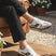 Lifestyle shot of bugatti Carmelo white sneakers, a modern, low-profile style with suede and white leather accents.
