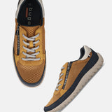 Pair of bugatti Bermudas yellow comfort sneakers; golden brown mesh with gray laces and navy accents.
