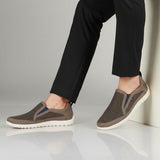 Lifestyle shot of bugatti Bermudas dark gray casual slip-on shoes with a breathable mesh upper and white sole.
