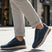Lifestyle view of bugatti Jerit dark blue comfort sneakers with laces and a side zipper.
