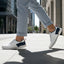 Lifestyle shot of bugatti Samana white leather sneakers with navy and red accents, worn with gray trousers.