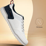 Side view of a white bugatti Samana sneaker with perforated leather, navy heel, gray laces, and a ridged sole.
