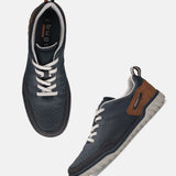 bugatti Samana Comfort Sneakers in dark blue leather, with lace-up closure and brown heel detail, displayed at an angle.