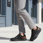 Person wearing Bugatti Anaheim Black Comfort Sneakers on a city street.