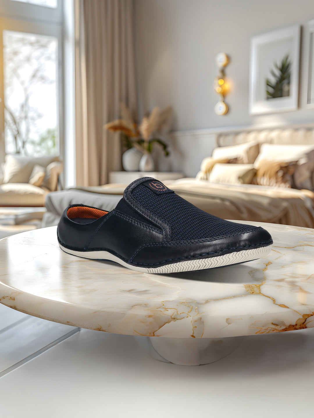 A blue Men's bugatti Mules featuring a round toe plain toe, zero heels heel. Made from premium genuine leather with a durable sebs (block copolymer) outsole, this slip-on design offers both style and comfort.