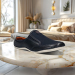 A blue Men's bugatti Mules featuring a round toe plain toe, zero heels heel. Made from premium genuine leather with a durable sebs (block copolymer) outsole, this slip-on design offers both style and comfort.