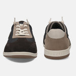 Brown suede sneakers by bugatti with a fabric upper and light-colored laces.