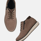 Taupe leather sneakers by bugatti with brown laces, a black zipper and white soles.