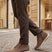 Lifestyle shot of bugatti Pramo Taupe premium leather comfort sneakers with zipper detail.
