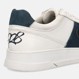 Off-white leather sneakers by bugatti with a navy heel accent and textured collar.