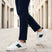 Lifestyle view of bugatti Franc off-white sneakers in premium leather with a navy stripe and white laces.