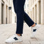 Lifestyle view of bugatti Franc off-white sneakers in premium leather with a navy stripe and white laces.