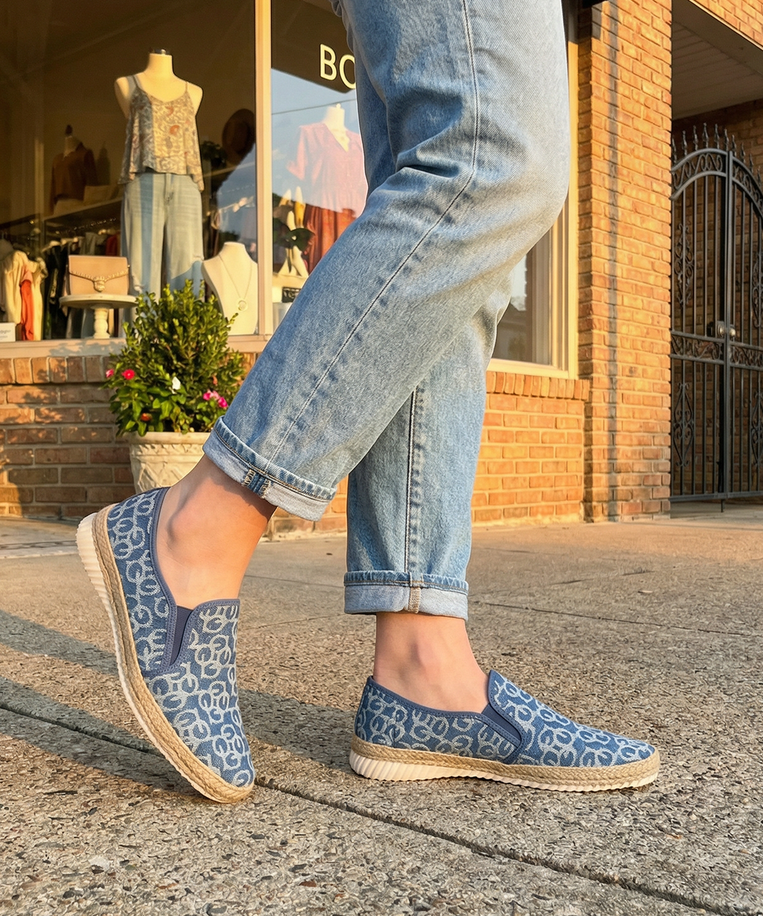 bugatti Colville Blue Comfort Slip-Ons casual shoes featuring a textured blue patterned upper and jute trim, being worn with jeans.