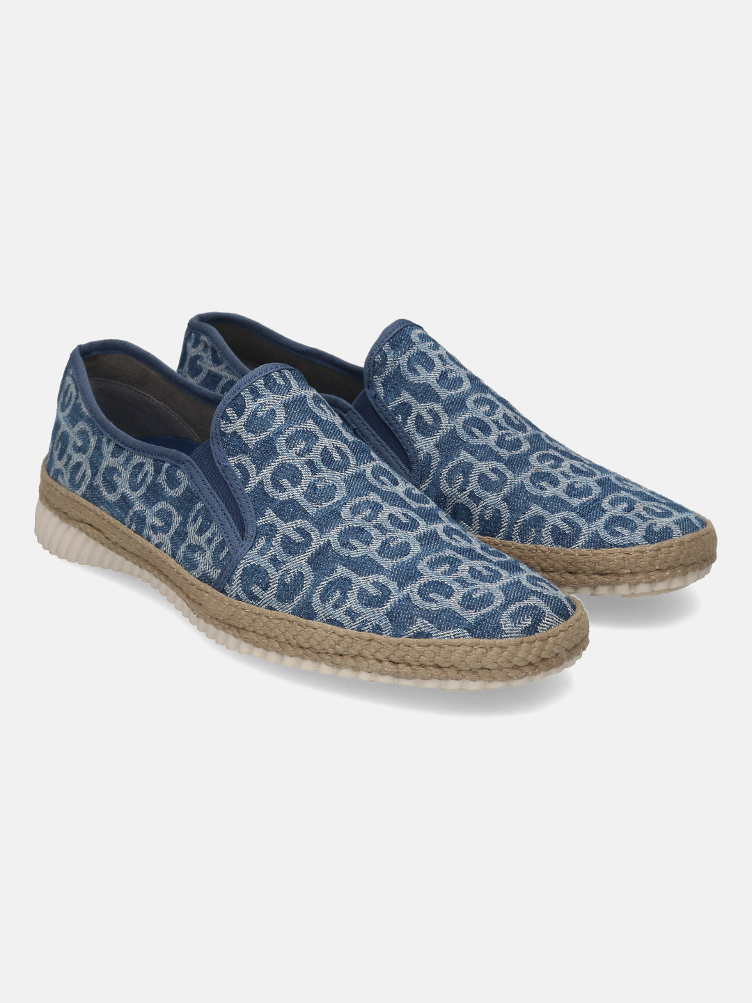 Blue denim comfort slip-ons by bugatti featuring an all-over geometric pattern, jute trim, and white soles.