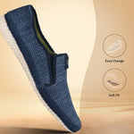 Blue slip-on casual shoe by bugatti with a textured upper and a white sole.