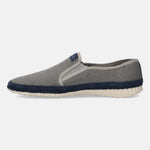 Light grey slip-on shoe by bugatti, featuring a navy blue accent stripe and textured outsole.