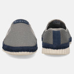 Gray slip-on shoes by bugatti with navy accent, textured knit, and a white sole, seen from the back.