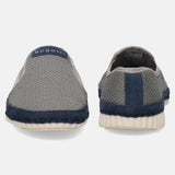 Gray slip-on shoes by bugatti with navy accent, textured knit, and a white sole, seen from the back.