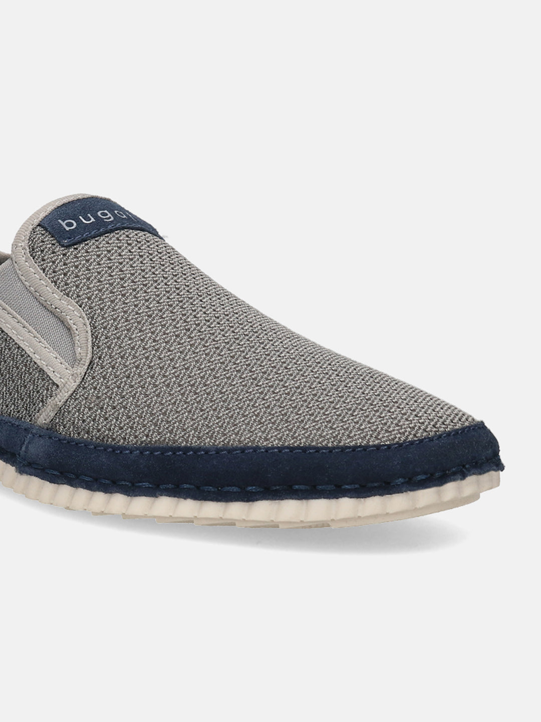 Light grey casual slip-on shoe by Bugatti featuring a textured upper, dark blue trim, and white sole.