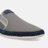 Light grey casual slip-on shoe by Bugatti featuring a textured upper, dark blue trim, and white sole.
