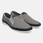 Light grey casual slip-ons by bugatti, featuring a woven texture and a navy blue accent trim.