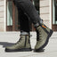 Lifestyle shot of bugatti Pallario comfort casual boots in dark green leather with black laces and soles.
