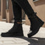 Lifestyle shot of bugatti Pallario comfort black casual boots, with zipper detail and lug sole, worn with dark rolled jeans.

