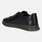 Black leather sneaker by bugatti with red stitching at the back and gray soles, in a side view.