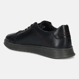 Black leather sneaker by bugatti with red stitching at the back and gray soles, in a side view.