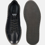 Black leather comfort sneakers by bugatti, featuring patterned laces and a textured sole.